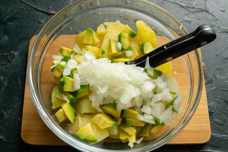Сладкий салатный лук режем кубиками, посыпаем солью, сбрызгиваем лимонным соком